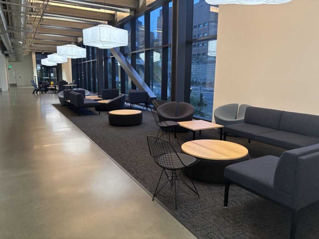 The first floor hallway of the Health Sciences Education Building, with various couches and chairs that students can use to study.