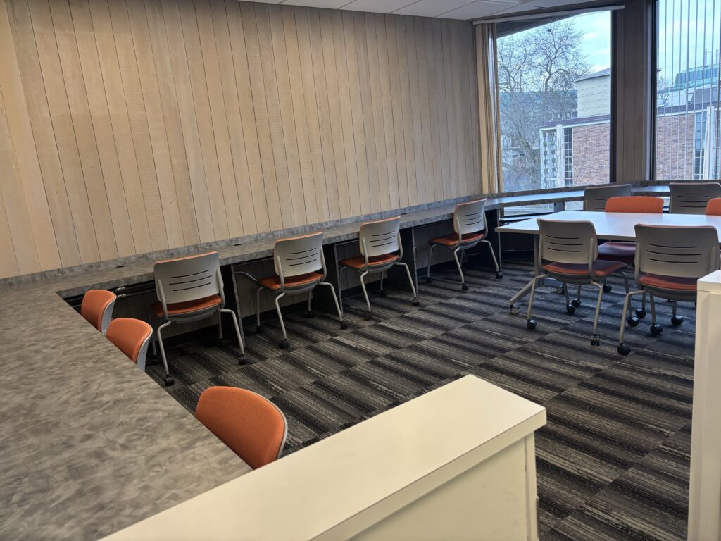 A medium-sized group study room in the South Campus Center. Seating is located around the edges of the room.