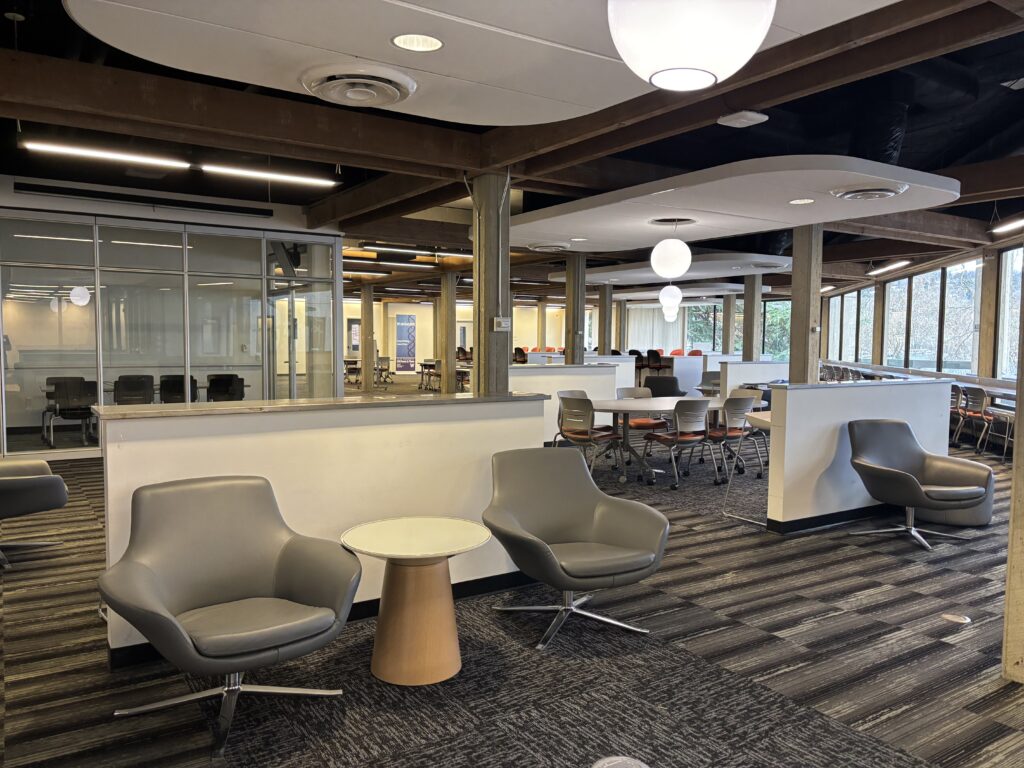 A large open space on the second floor of the South Campus Center with a variety of seating options in sections separated by half walls.