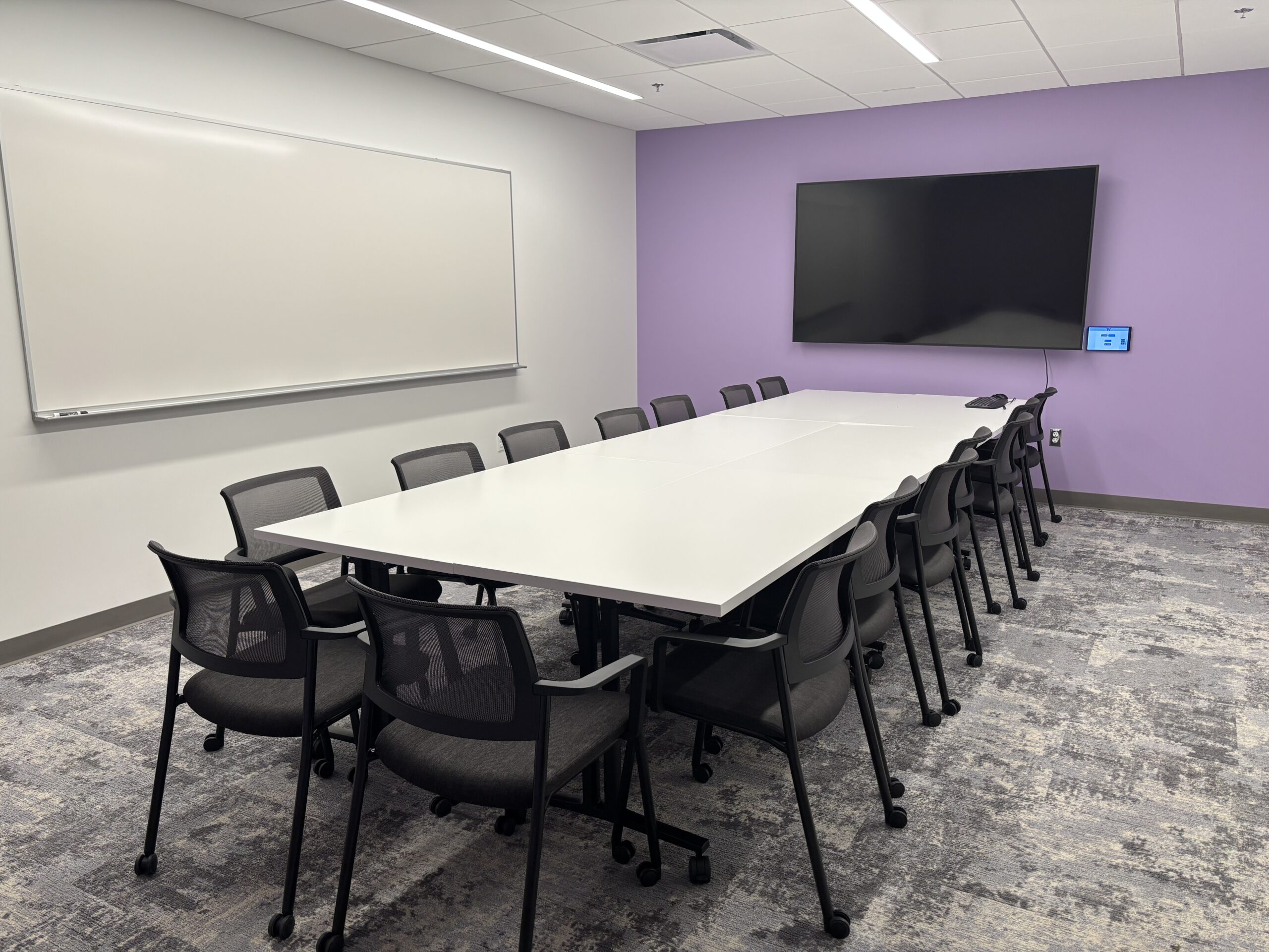 Photo of the T6 simulation suite's debrief rooms, showing the layout of tables and chairs.